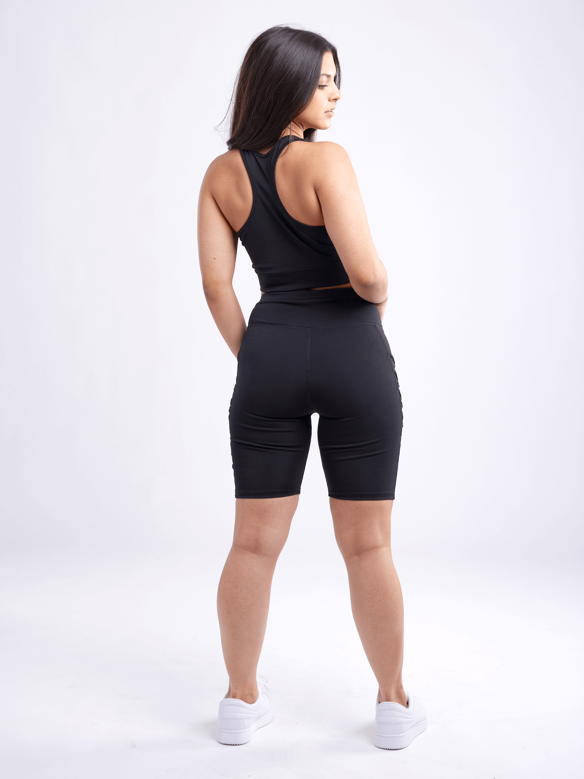 A lightweight women's racerback crop tank top in a stylish design, perfect for workouts and casual wear, showcasing its breathable fabric and seamless construction.