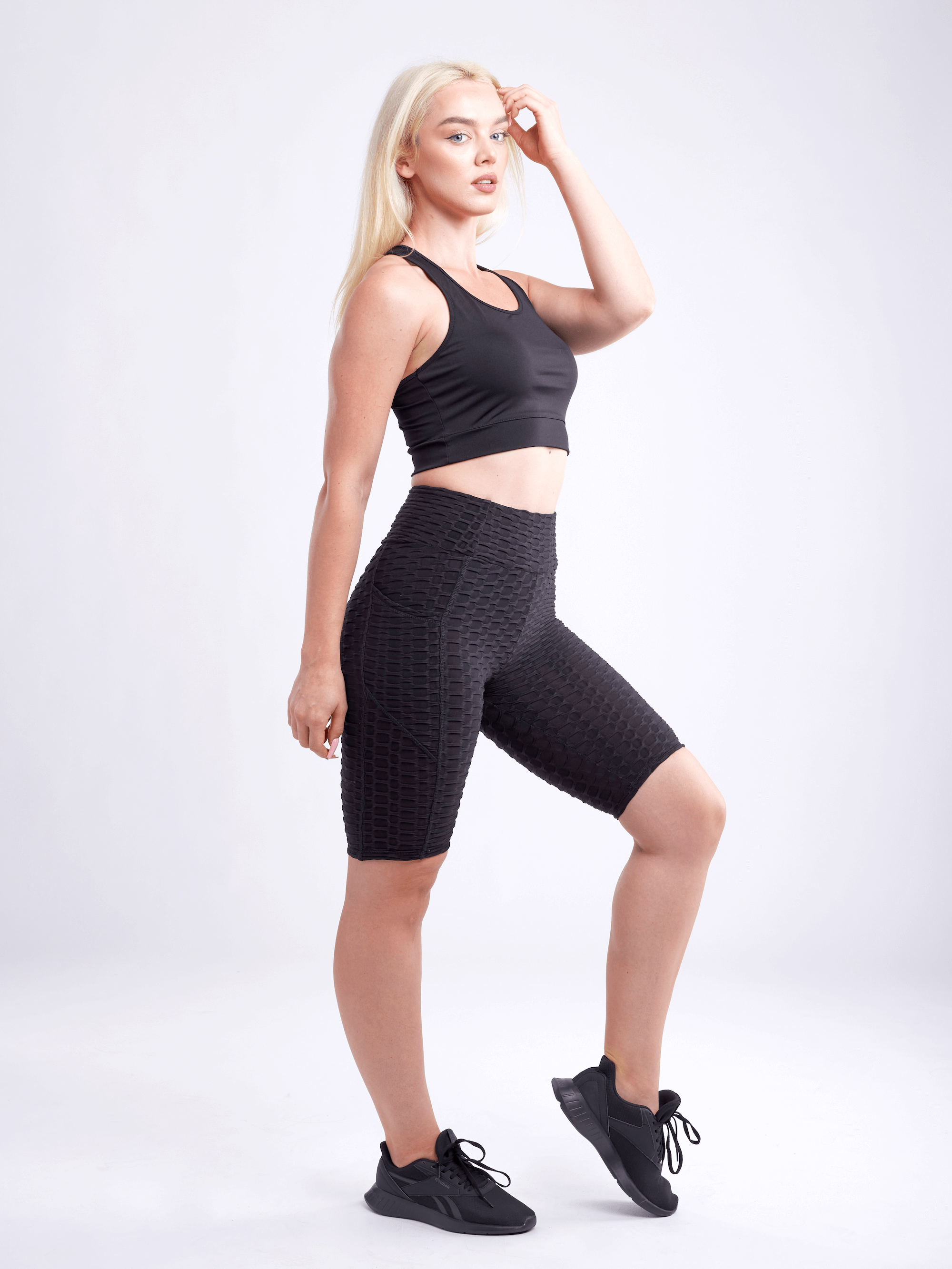 A lightweight women's racerback crop tank top in a stylish design, perfect for workouts and casual wear, showcasing its breathable fabric and seamless construction.