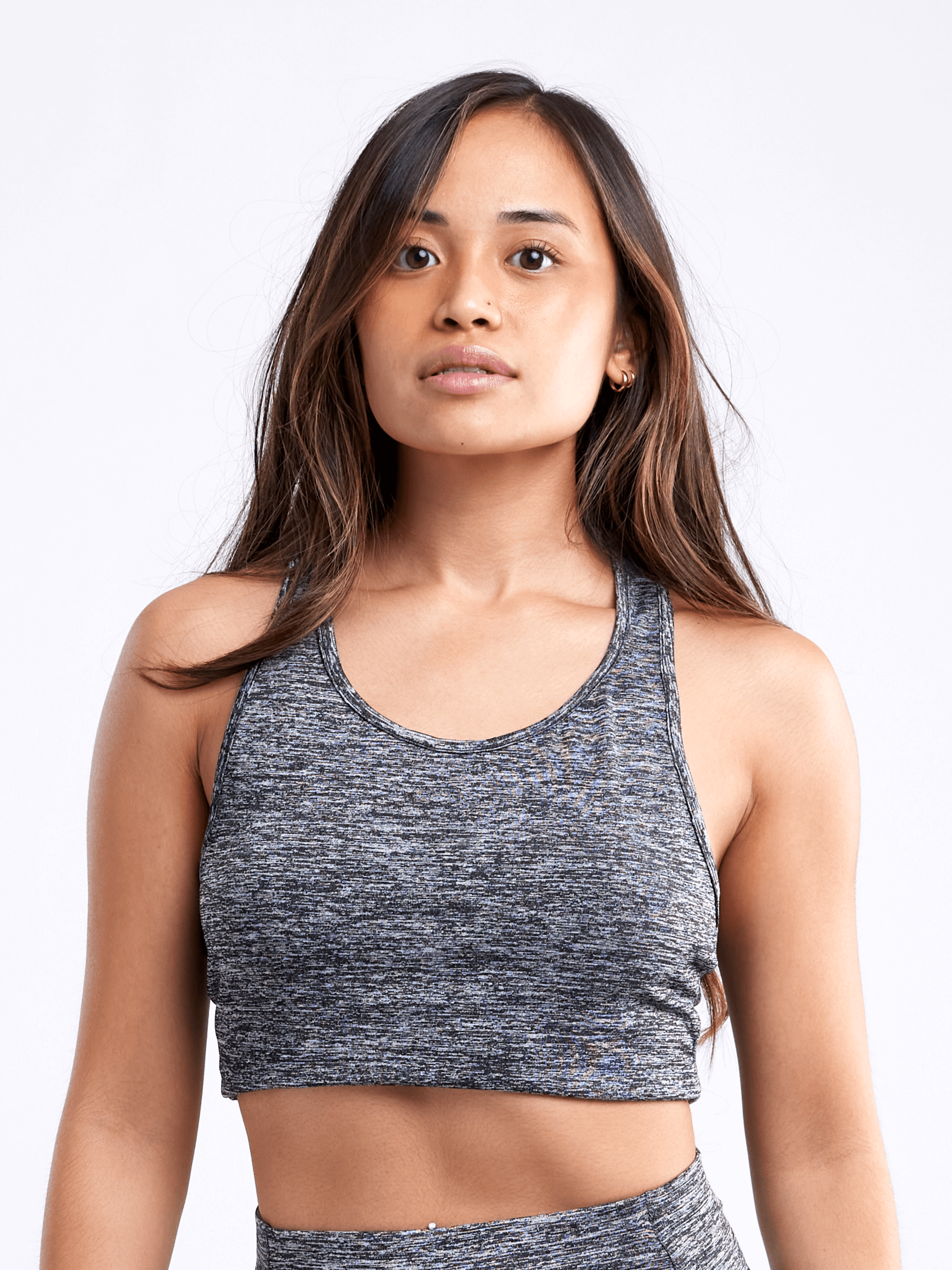 A lightweight women's racerback crop tank top in a stylish design, perfect for workouts and casual wear, showcasing its breathable fabric and seamless construction.