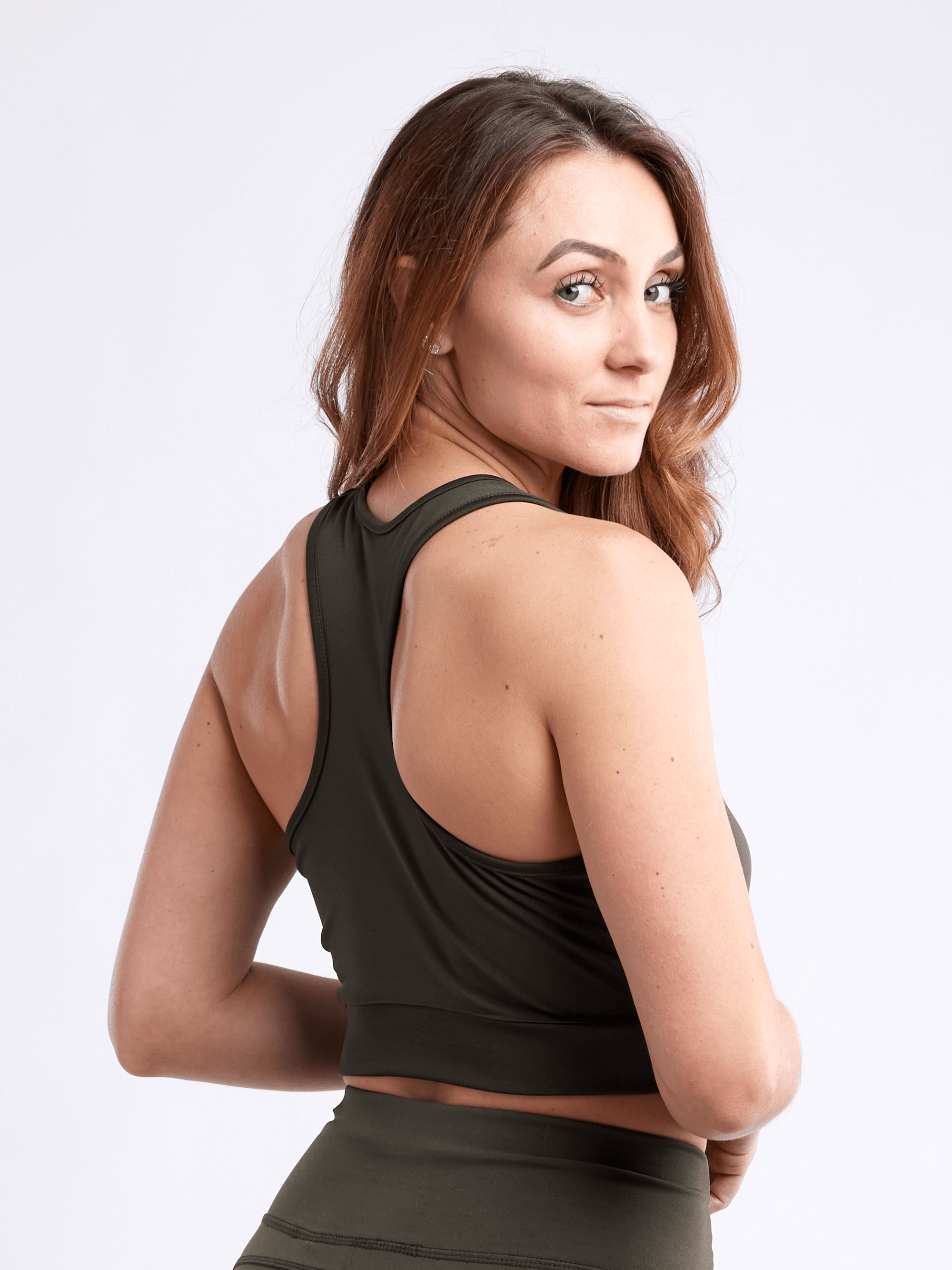 A lightweight women's racerback crop tank top in a stylish design, perfect for workouts and casual wear, showcasing its breathable fabric and seamless construction.