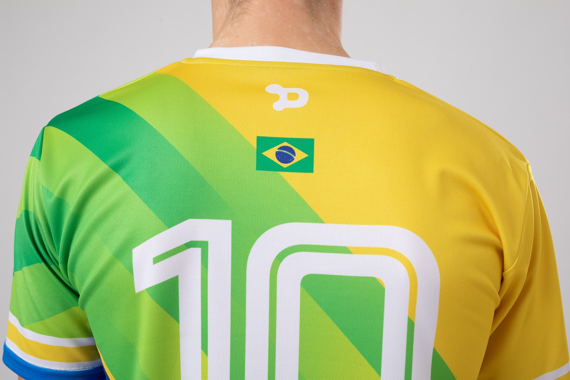 Ronaldinho Brazil Jersey replica featuring V-Neck design and sublimated silhouette badge.