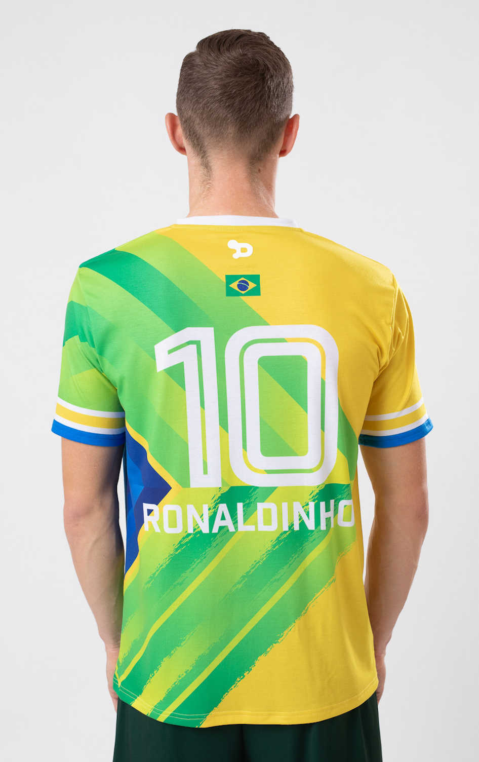 Ronaldinho Brazil Jersey featuring a V-Neck design, woven badge with Ronaldinho's silhouette, and soft polyester/elastane fabric.