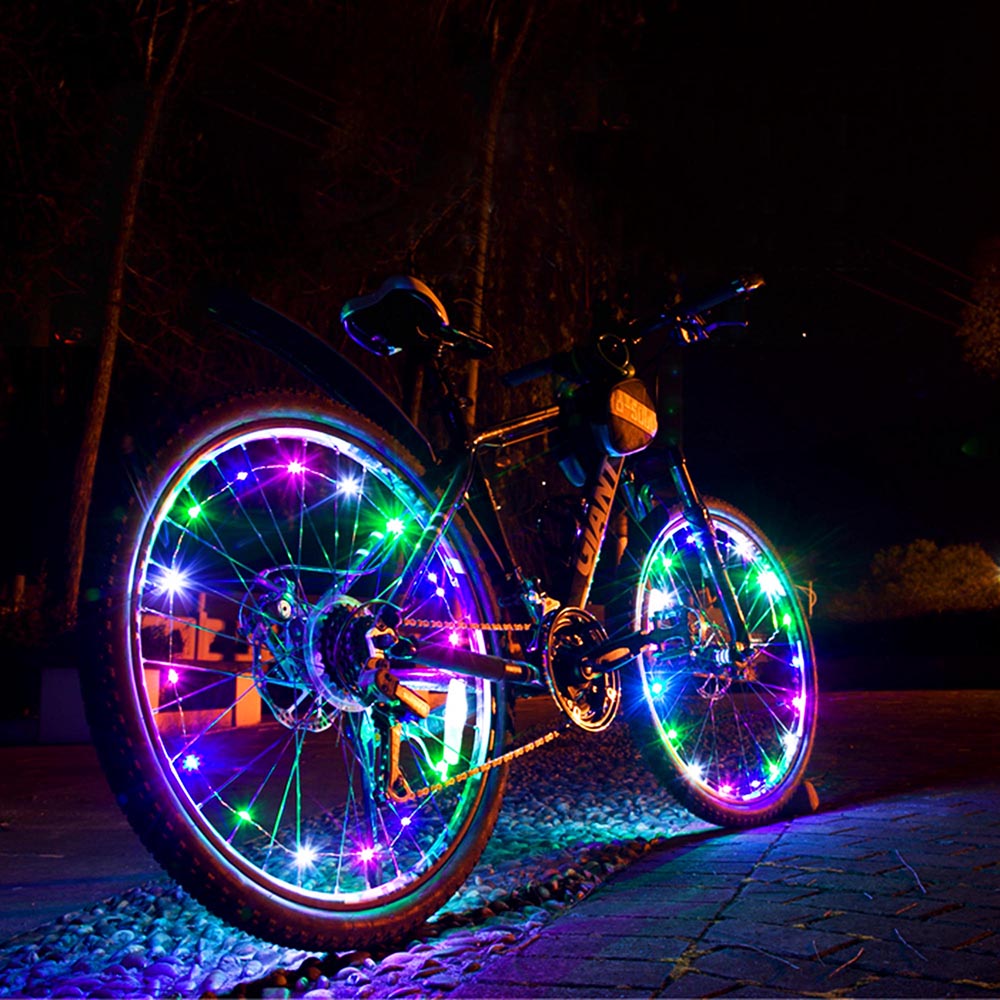 Colorful Mini LED Bike Wheel Spoke Light attached to a bicycle wheel, illuminating with vibrant colors for enhanced visibility during night rides.