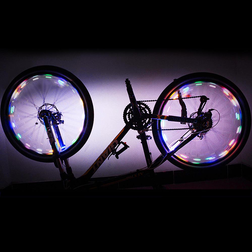 Colorful Mini LED Bike Wheel Spoke Light attached to a bicycle wheel, illuminating with vibrant colors for enhanced visibility during night rides.