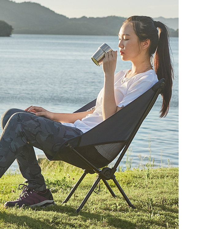 Ultralight Outdoor Folding Camping Chair in a natural setting, showcasing its lightweight design and durable fabric.