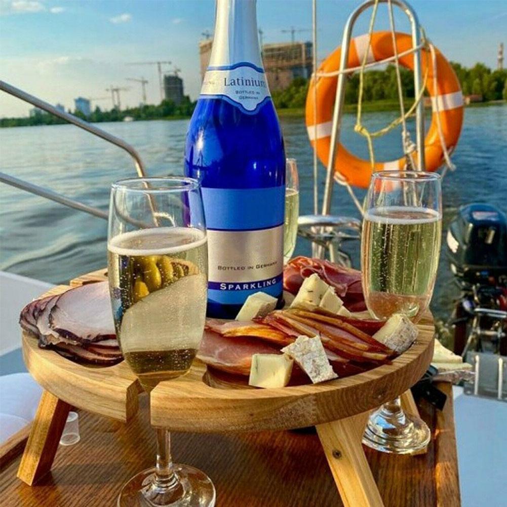 Wooden outdoor folding picnic table with glass holder, showcasing its modern design and functionality for outdoor dining.