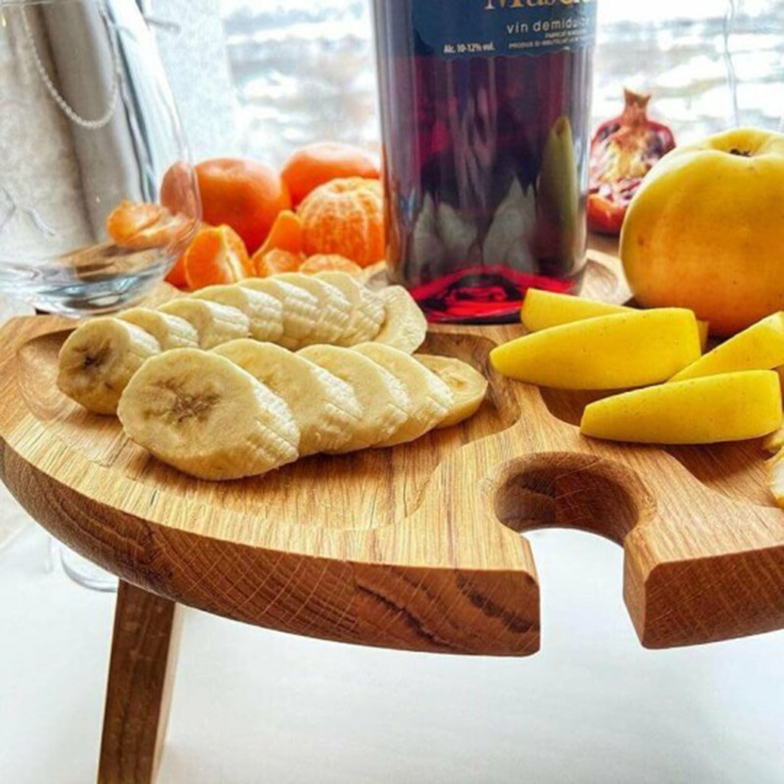 Wooden outdoor folding picnic table with glass holder, showcasing its modern design and functionality for outdoor dining.