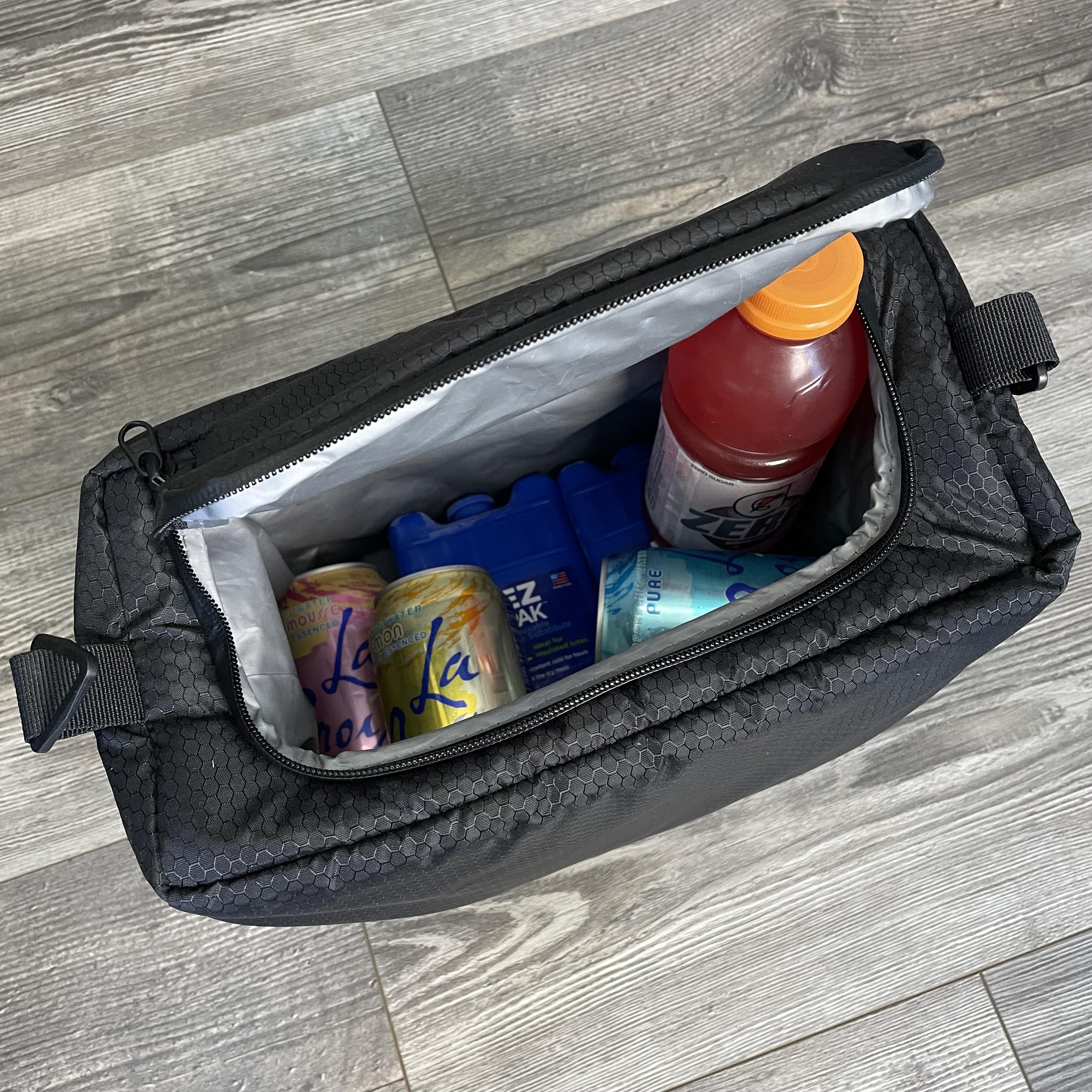 A waterproof and insulated 365 Backpack Cooler Insert by Hab Gear, designed to hold up to 18 cans, featuring snap attachments for secure fitting.