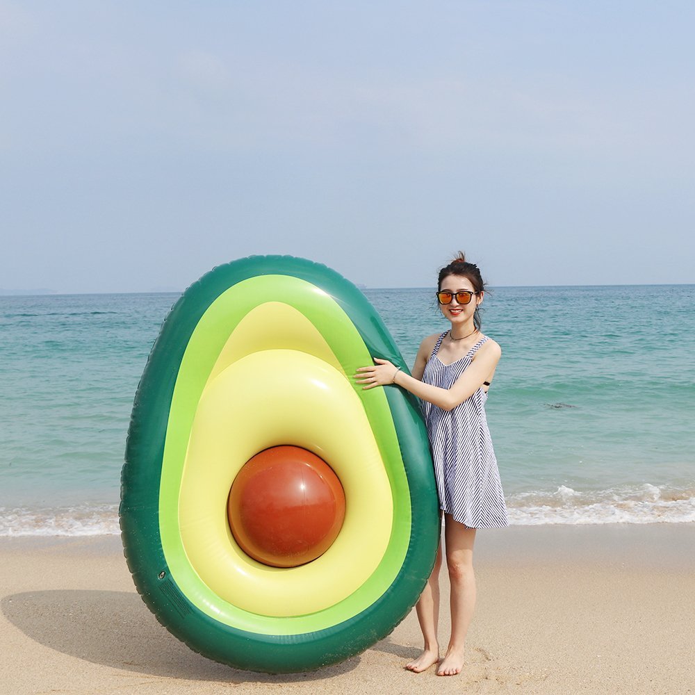 A vibrant inflatable giant avocado pool float, perfect for summer fun, showcasing its bright green and yellow colors.