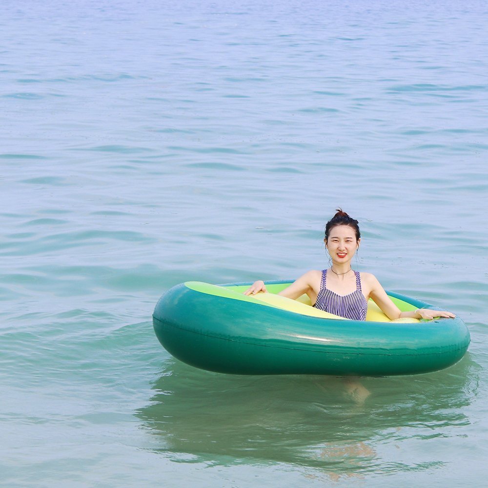 A vibrant inflatable giant avocado pool float, perfect for summer fun, showcasing its bright green and yellow colors.