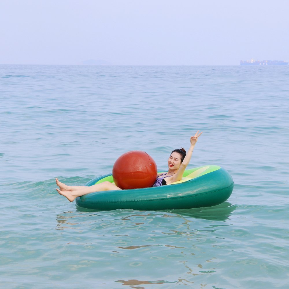 A vibrant inflatable giant avocado pool float, perfect for summer fun, showcasing its bright green and yellow colors.