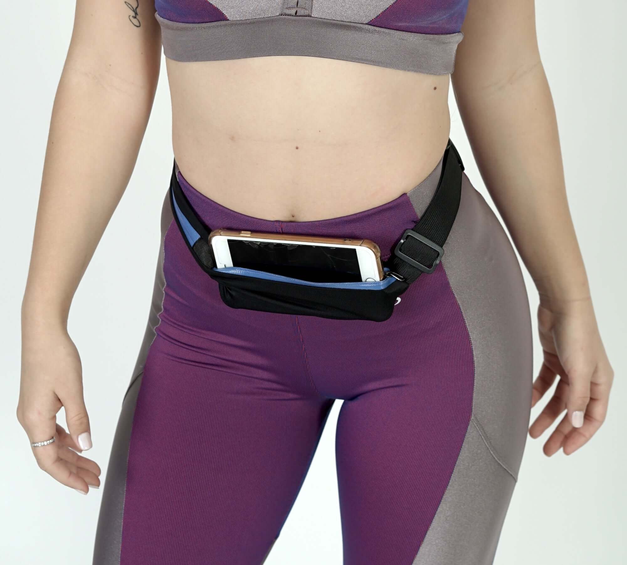 Stride Dual Pocket Running Belt in black, featuring two water-resistant pockets and an adjustable elastic waist belt, ideal for outdoor activities.