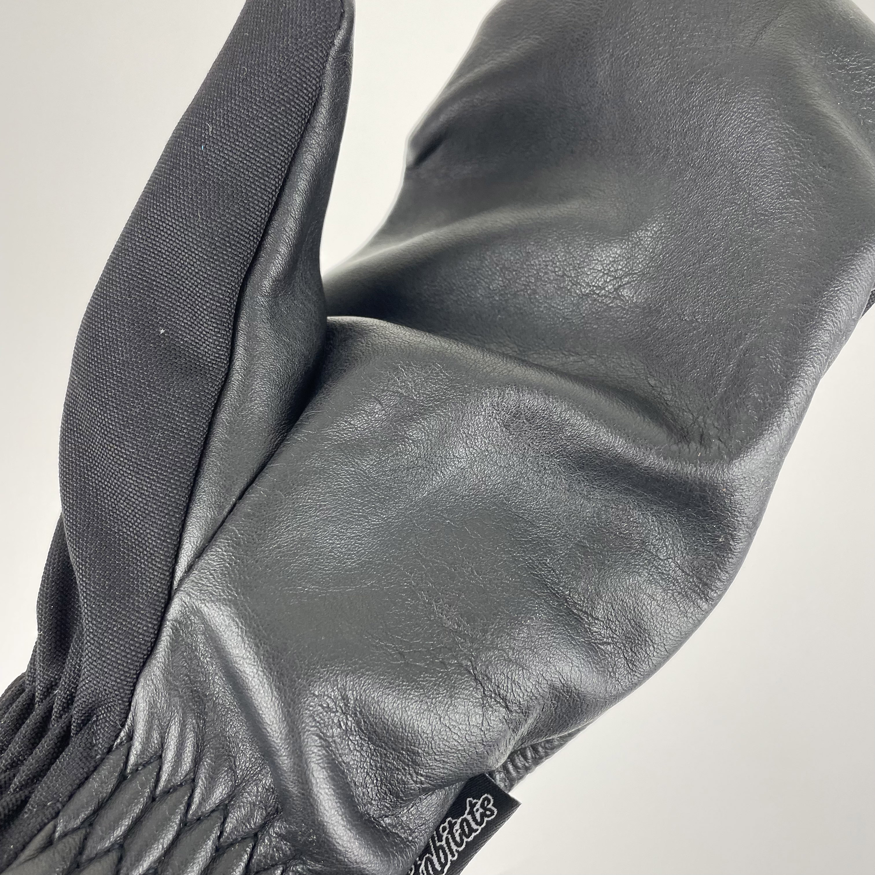 Super Shell Mitten featuring durable cowhide leather palm and ballistic nylon top, designed for outdoor activities and harsh conditions.