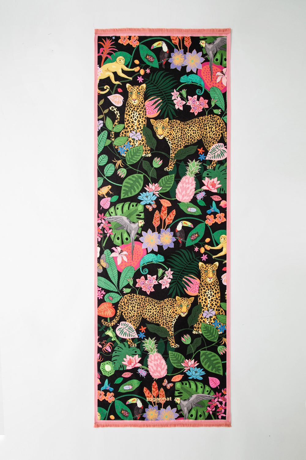 The Spotty Paradise Premium Yoga Towel featuring vibrant animal print and cute tassels, perfect for yoga enthusiasts.