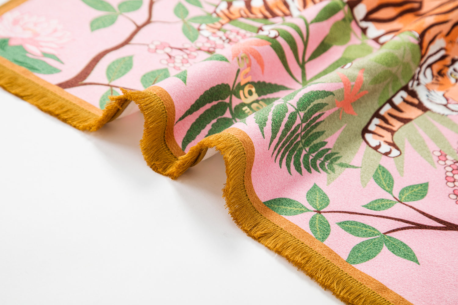 The Striped Charmer yoga towel featuring a majestic feline design surrounded by cherry blossoms, with cute tassels on the edges.