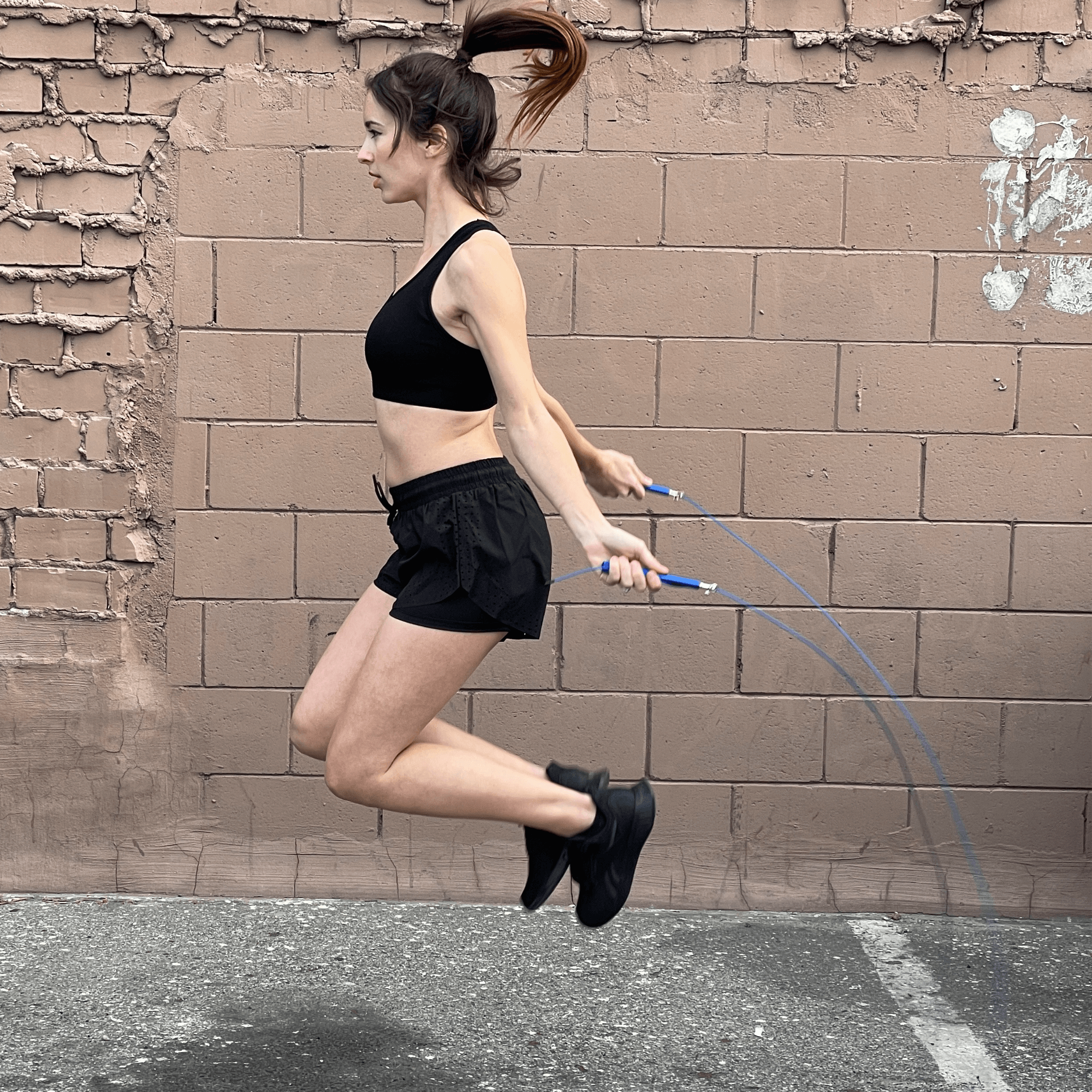 A weighted jump rope with adjustable steel wire cable, featuring sure-grip handles and a compact design for portable workouts.