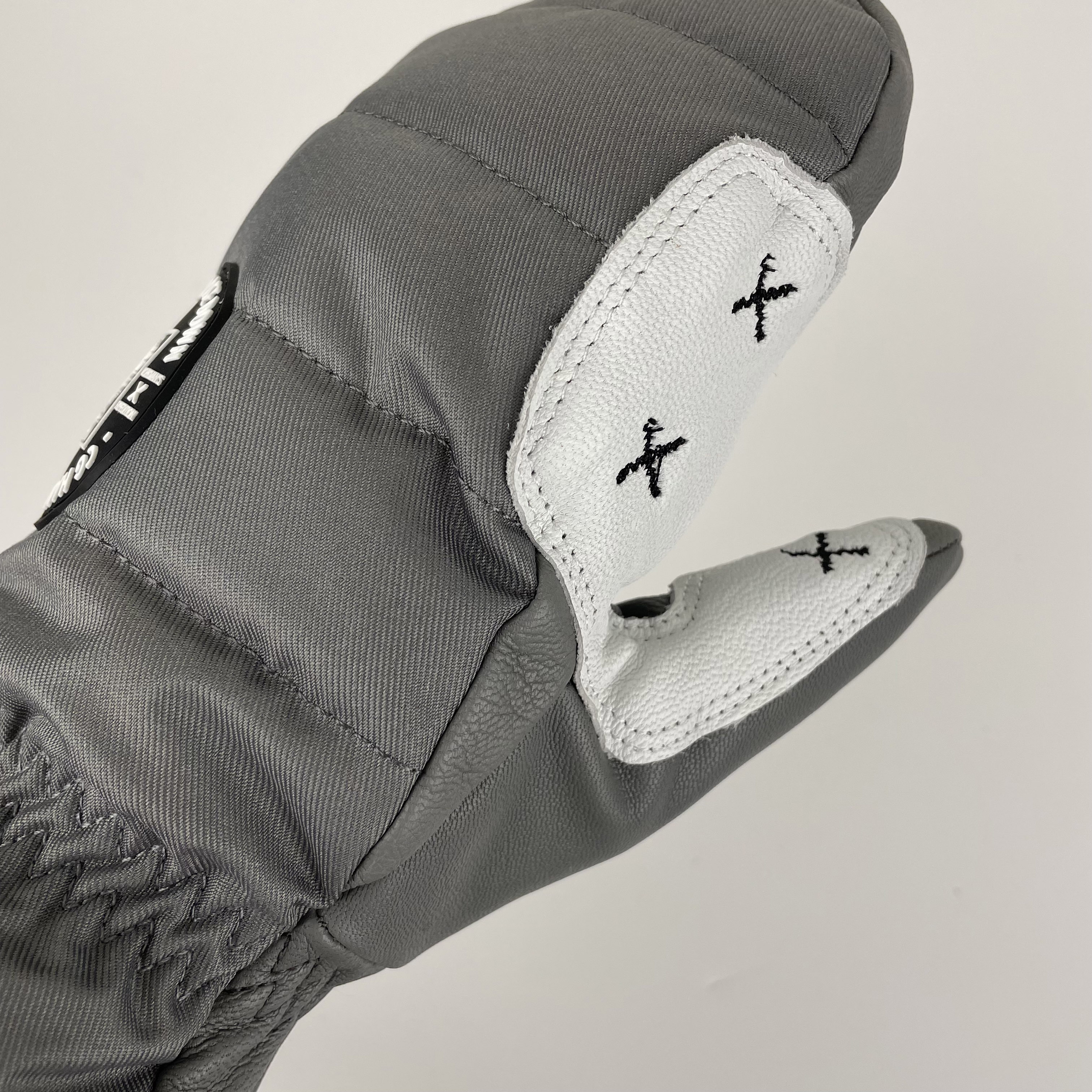 Workman's Mitten X featuring genuine leather palm and premium goose down insulation, designed for maximum warmth in winter conditions.