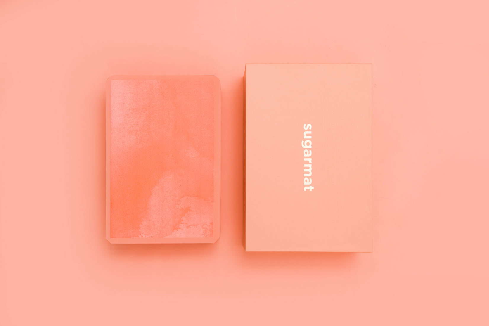 A pink yoga block made of high-density EVA foam, featuring beveled edges for grip, ideal for supporting various yoga poses.