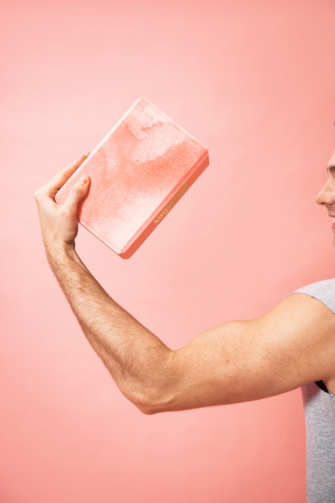 A pink yoga block made of high-density EVA foam, featuring beveled edges for grip, ideal for supporting various yoga poses.