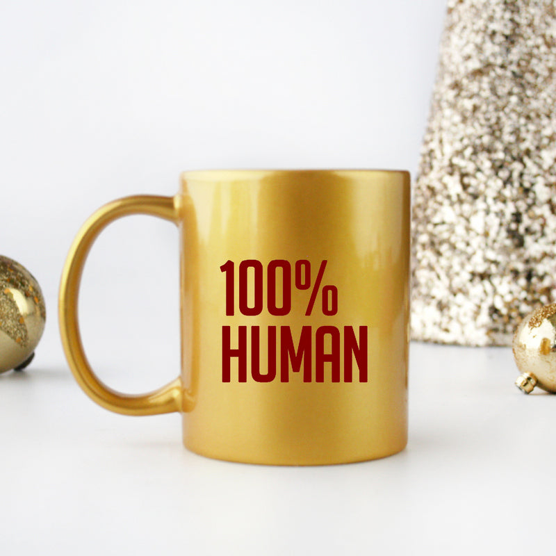 A stylish 100% Human Gold & Silver Mug made of ceramic with a luxurious gold metallic coating, showcasing its elegant design.