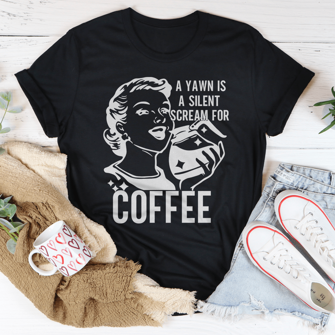 A comfortable and stylish t-shirt featuring the phrase 'A Yawn Is A Silent Scream For Coffee' printed on it, made from soft ring-spun cotton.