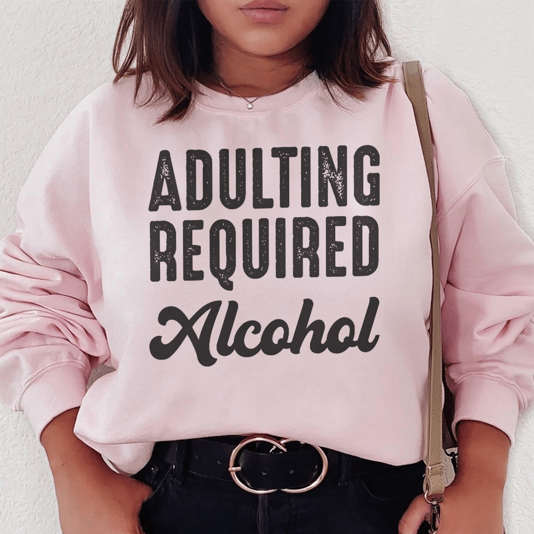 Cozy 'Adulting Requires Alcohol' hoodie featuring a humorous design, made from soft cotton/poly fleece blend.