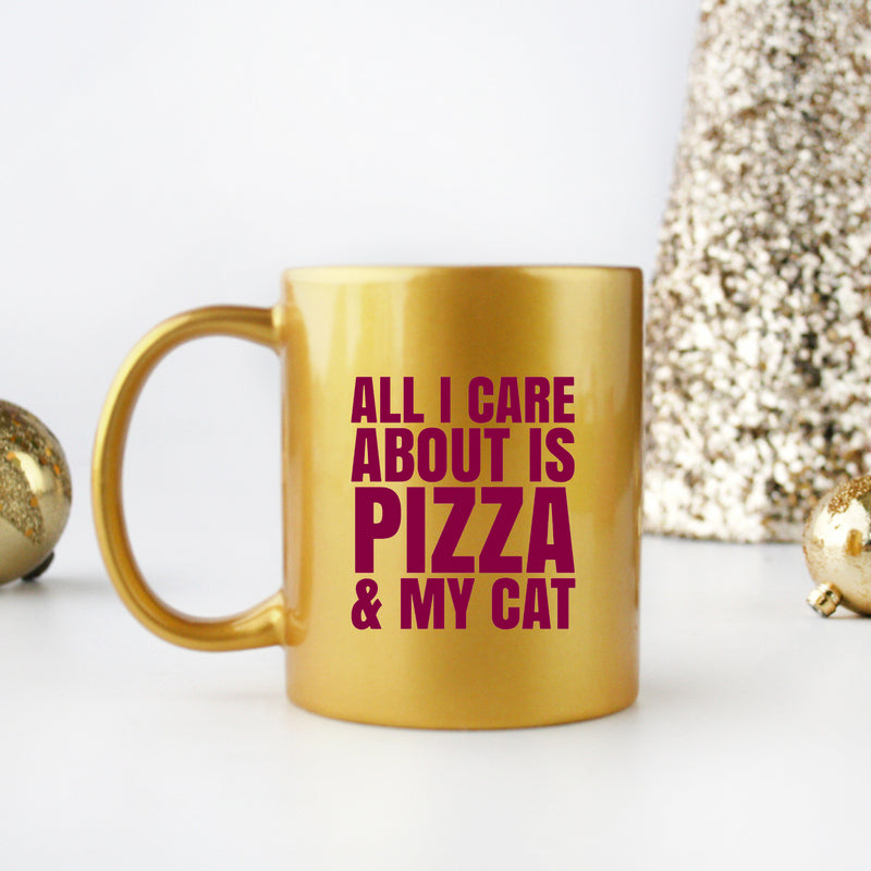 Ceramic gold and silver mug with cat and pizza design, perfect for coffee or tea.