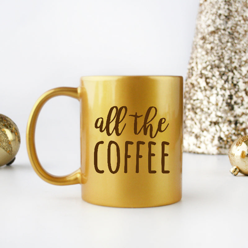 A luxurious gold and silver ceramic coffee mug with a sleek design, perfect for enjoying hot beverages.