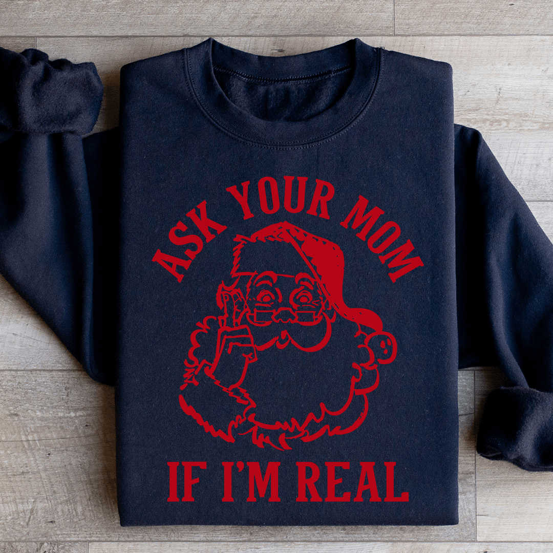 A cozy sweatshirt featuring the phrase 'Ask Your Mom If I'm Real', designed by top artists, showcasing a unique and stylish look.