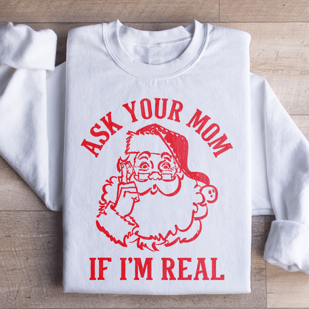 A cozy sweatshirt featuring the phrase 'Ask Your Mom If I'm Real', designed by top artists, showcasing a unique and stylish look.