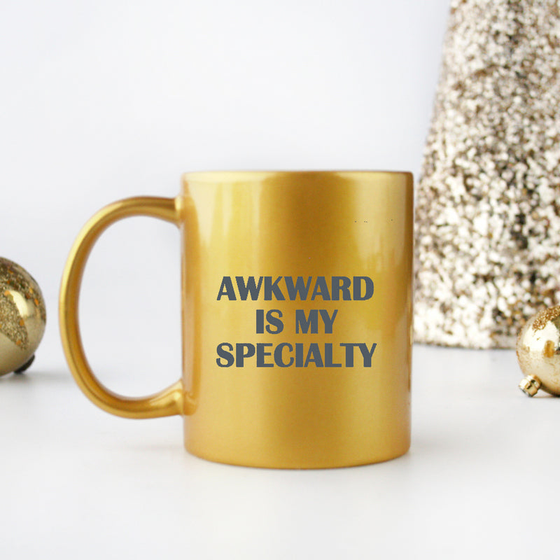 Awkward Is My Specialty Gold & Silver Mug with unique design and gold metallic coating, showcasing its ceramic material.