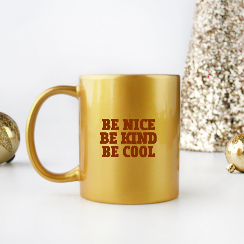 A stylish gold and silver ceramic mug with the phrase 'Be Nice Be Kind Be Cool' elegantly displayed, perfect for coffee or tea.