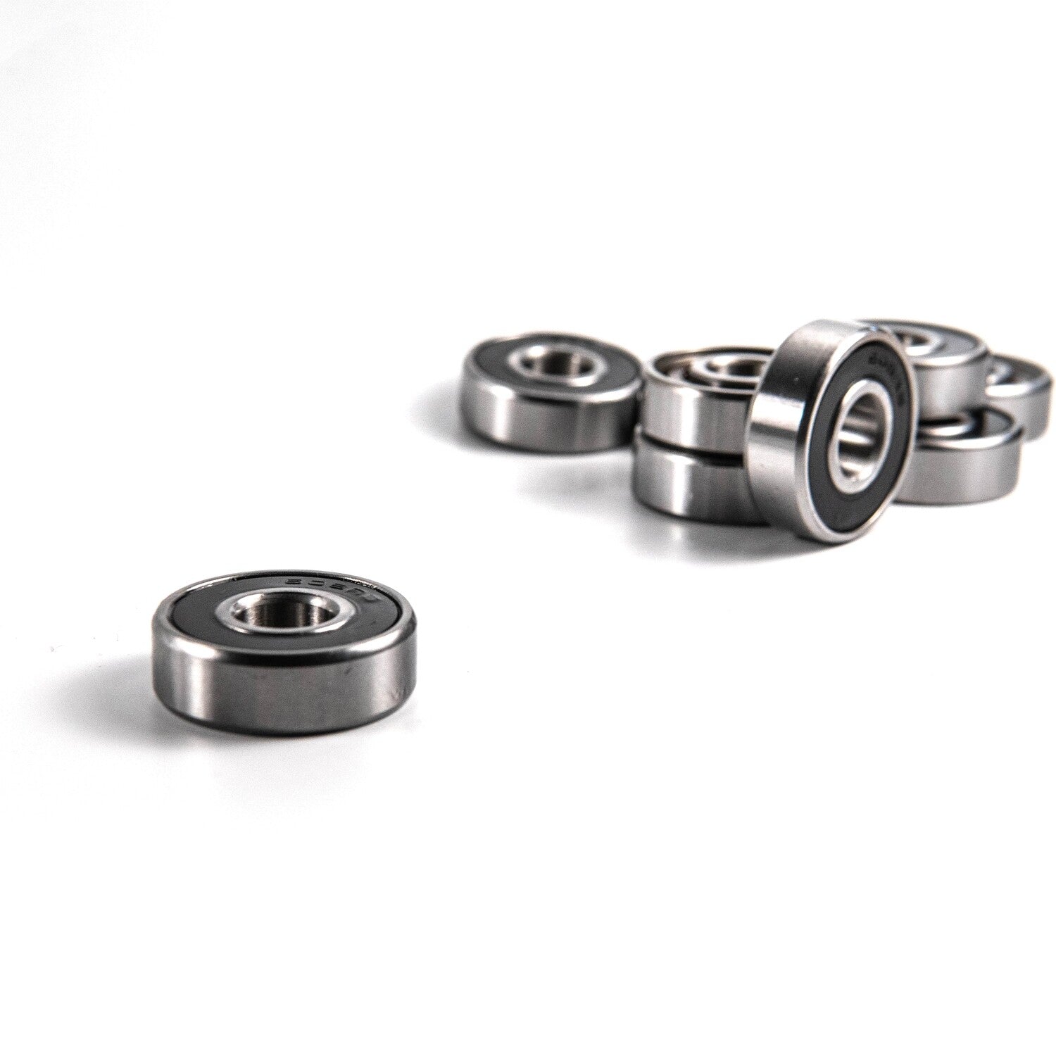 High-performance skateboard bearings designed for ultra-smooth rides and durability, featuring chrome steel balls and removable rubber shields.