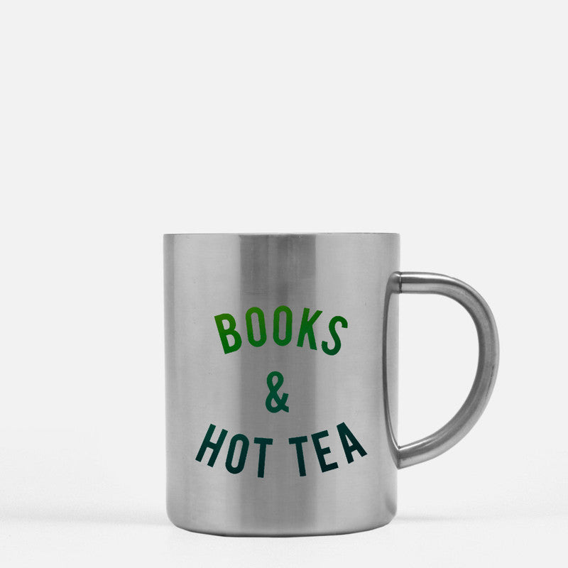 Elegant gold and silver ceramic mug designed for tea and book lovers, featuring a unique design.