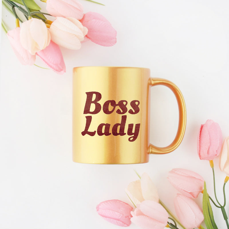 A stylish Boss Lady Gold & Silver Mug featuring a gold metallic coating and sleek design, perfect for coffee or tea.