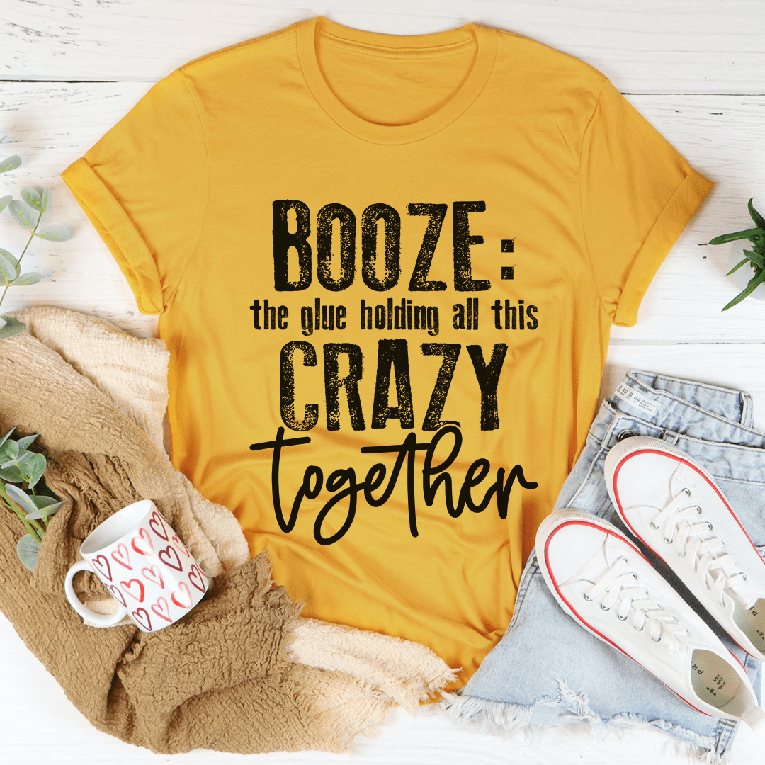 Booze The Glue Holding All This Crazy Together T-Shirt displayed on a hanger, showcasing its soft cotton fabric and playful print.