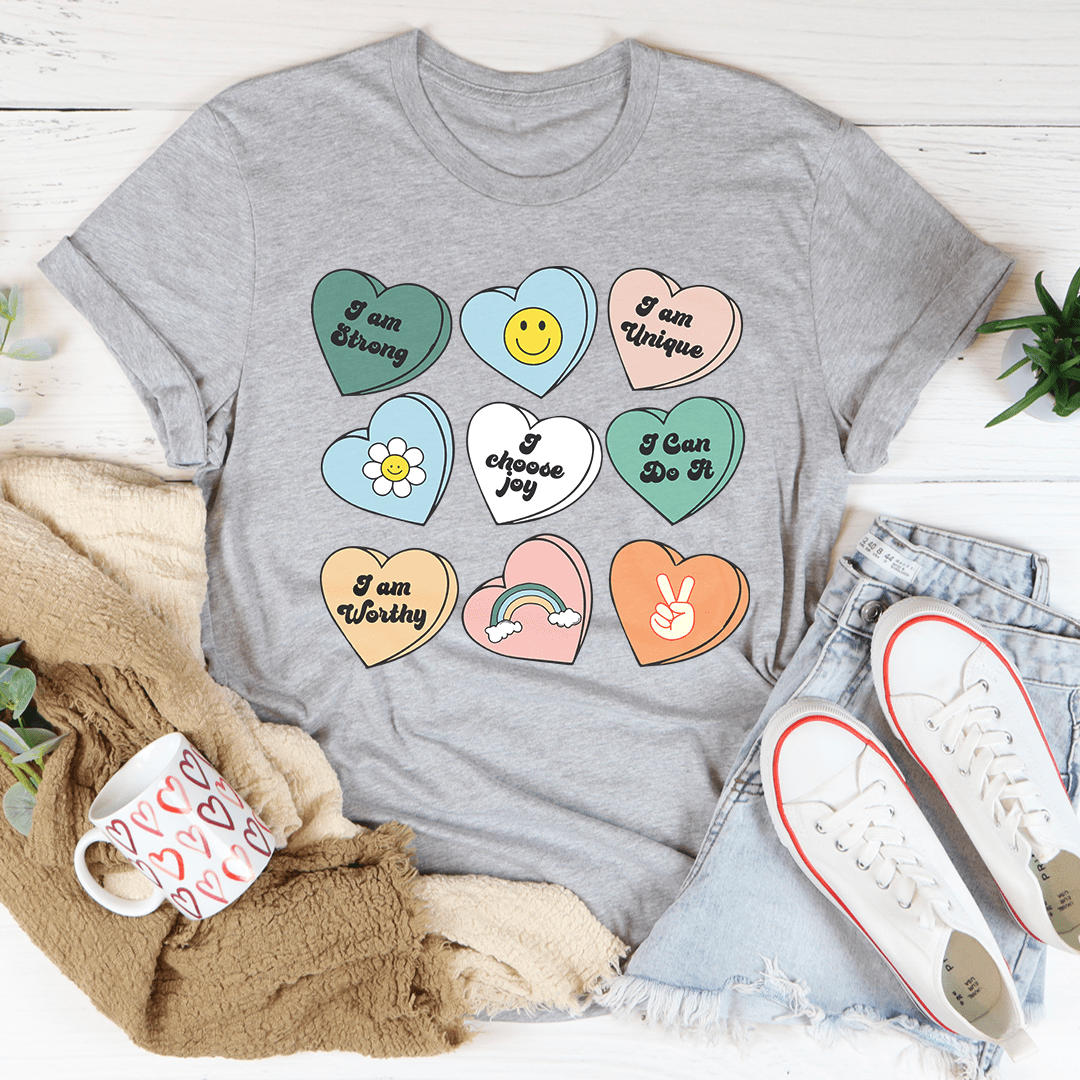 Candy Hearts Positivity Affirmations T-Shirt featuring vibrant colors and affirmations, made from soft ring-spun cotton.