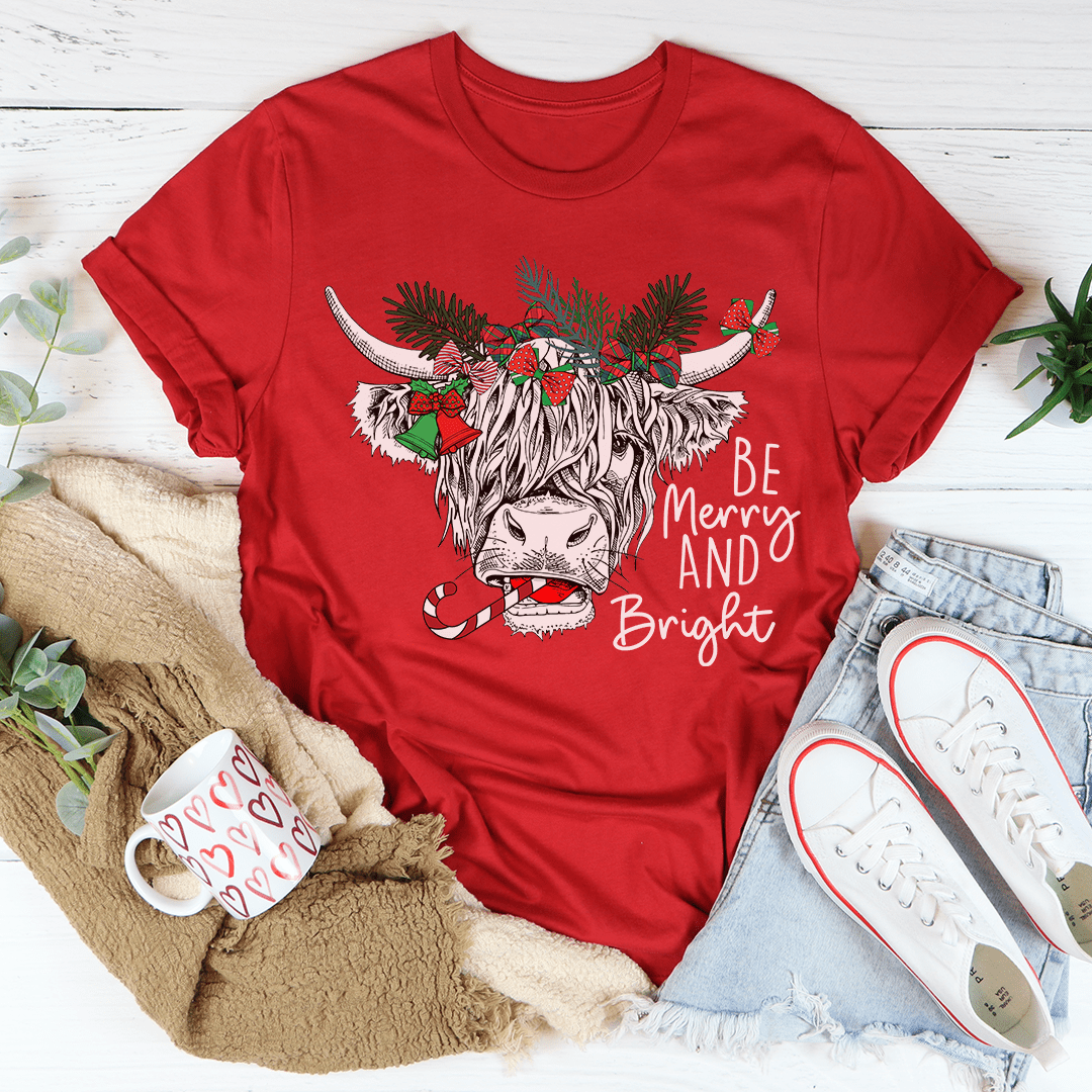 A festive Christmas Cow T-Shirt featuring a playful cow design, made from soft cotton with double stitching for durability.