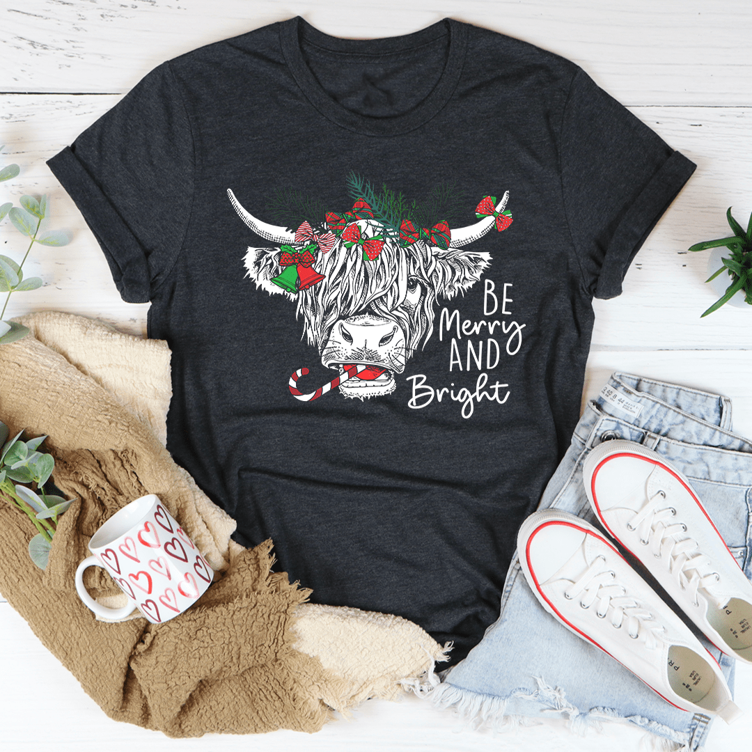 A festive Christmas Cow T-Shirt featuring a playful cow design, made from soft cotton with double stitching for durability.