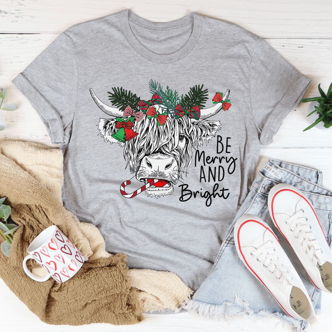 A festive Christmas Cow T-Shirt featuring a playful cow design, made from soft cotton with double stitching for durability.