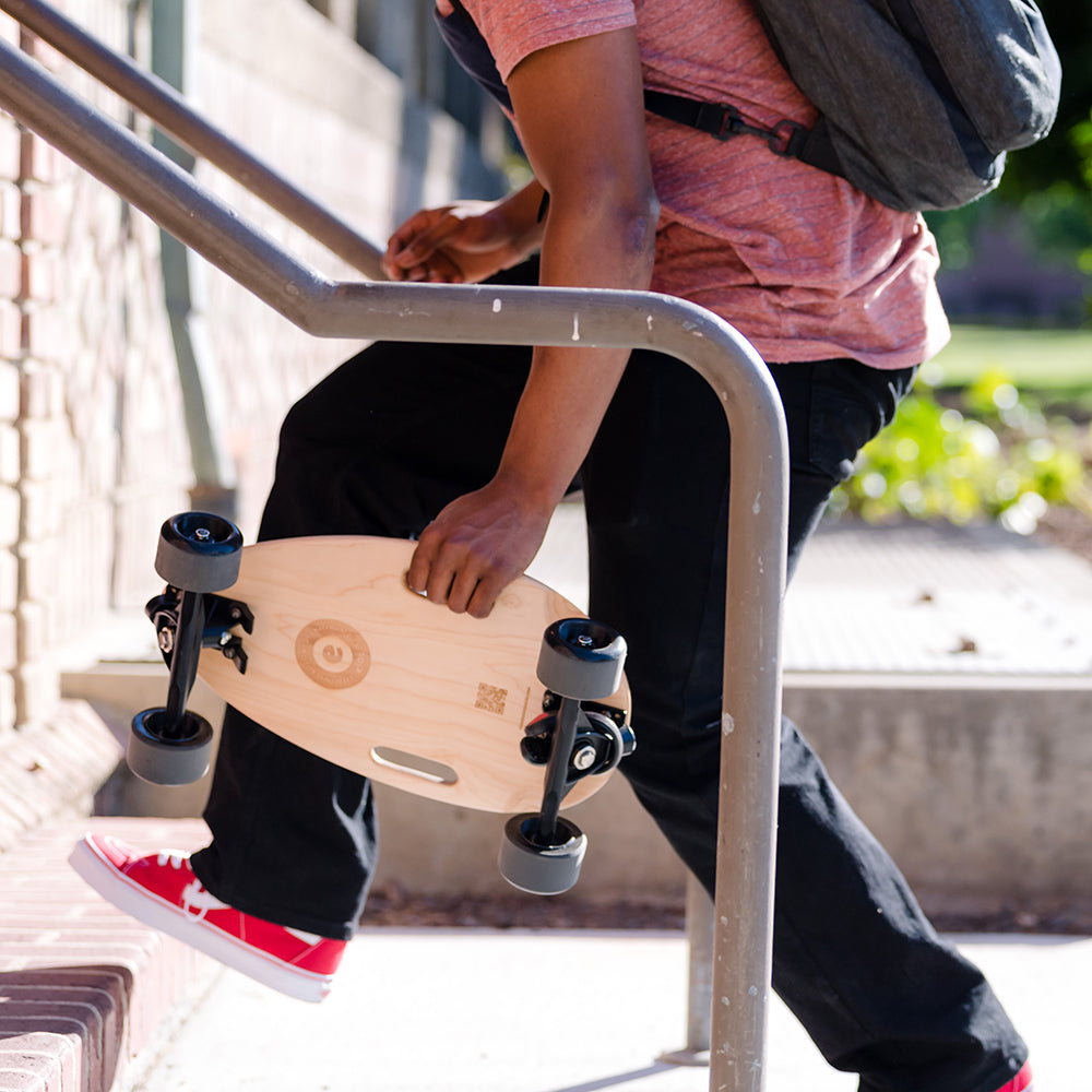 Complete Skateboard in Maroon Red, showcasing its sleek design and lightweight build, perfect for commuting and recreational use.