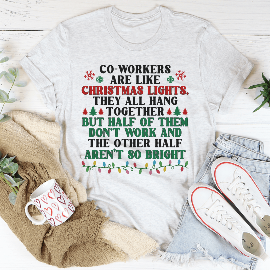 A festive t-shirt featuring the phrase 'Coworkers Are Like Christmas Lights' printed in colorful letters, made from soft cotton fabric.