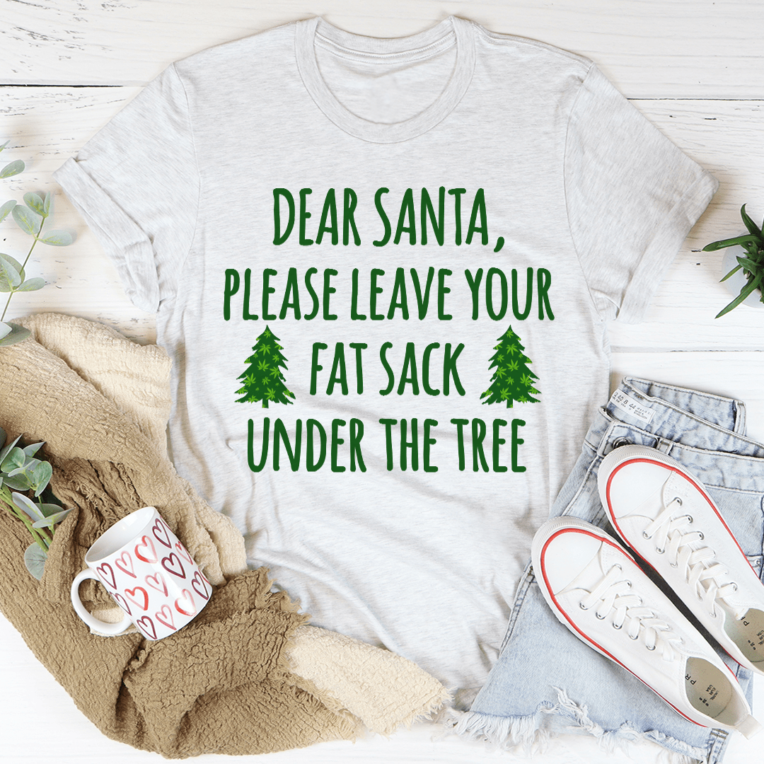 A festive t-shirt featuring the phrase 'Dear Santa Leave Your Fat Sack Under The Tree' in playful typography, made from soft cotton.