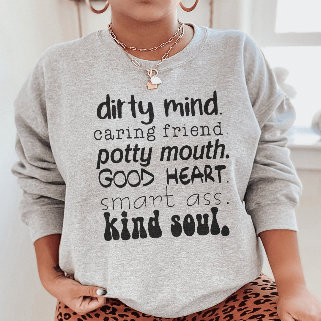 A cozy sweatshirt featuring the phrase 'Dirty Mind Caring Friend Potty Mouth Good Heart', designed by top artists, showcasing a unique and stylish look.