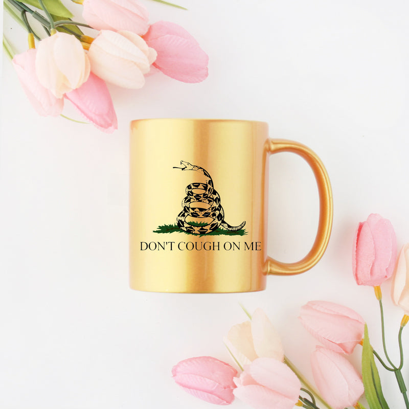 Ceramic mug with gold metallic coating featuring a humorous COVID-19 design, perfect for coffee or tea.