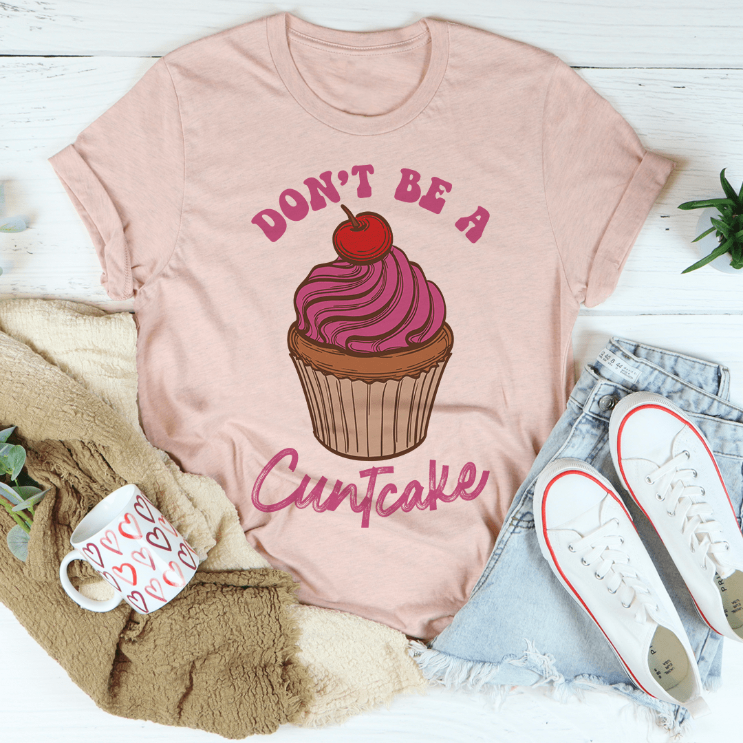 A stylish Don't Be A Cuntcake Tee made from soft ring-spun cotton, featuring a humorous design and durable double stitching.