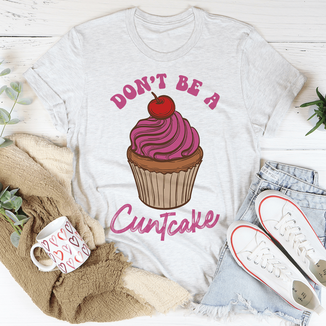 A stylish Don't Be A Cuntcake Tee made from soft ring-spun cotton, featuring a humorous design and durable double stitching.