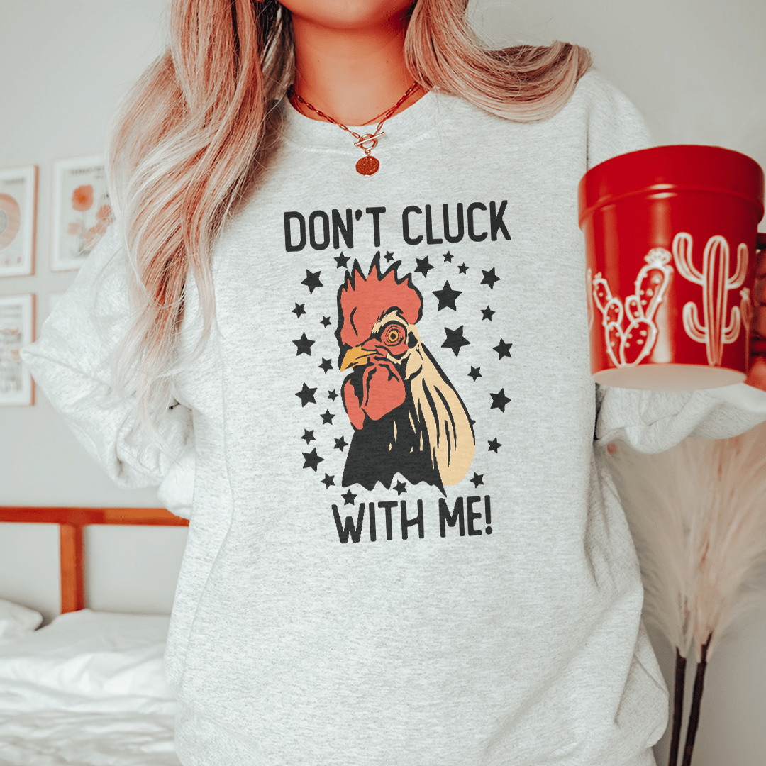 A stylish sweatshirt featuring the phrase 'Don’t Cluck With Me', designed by top artists, showcasing a cozy fleece material.