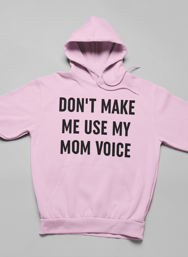 A cozy hoodie featuring the phrase 'Don't Make Me Use My Mom Voice' designed by top artists, showcasing a stylish and comfortable fit.