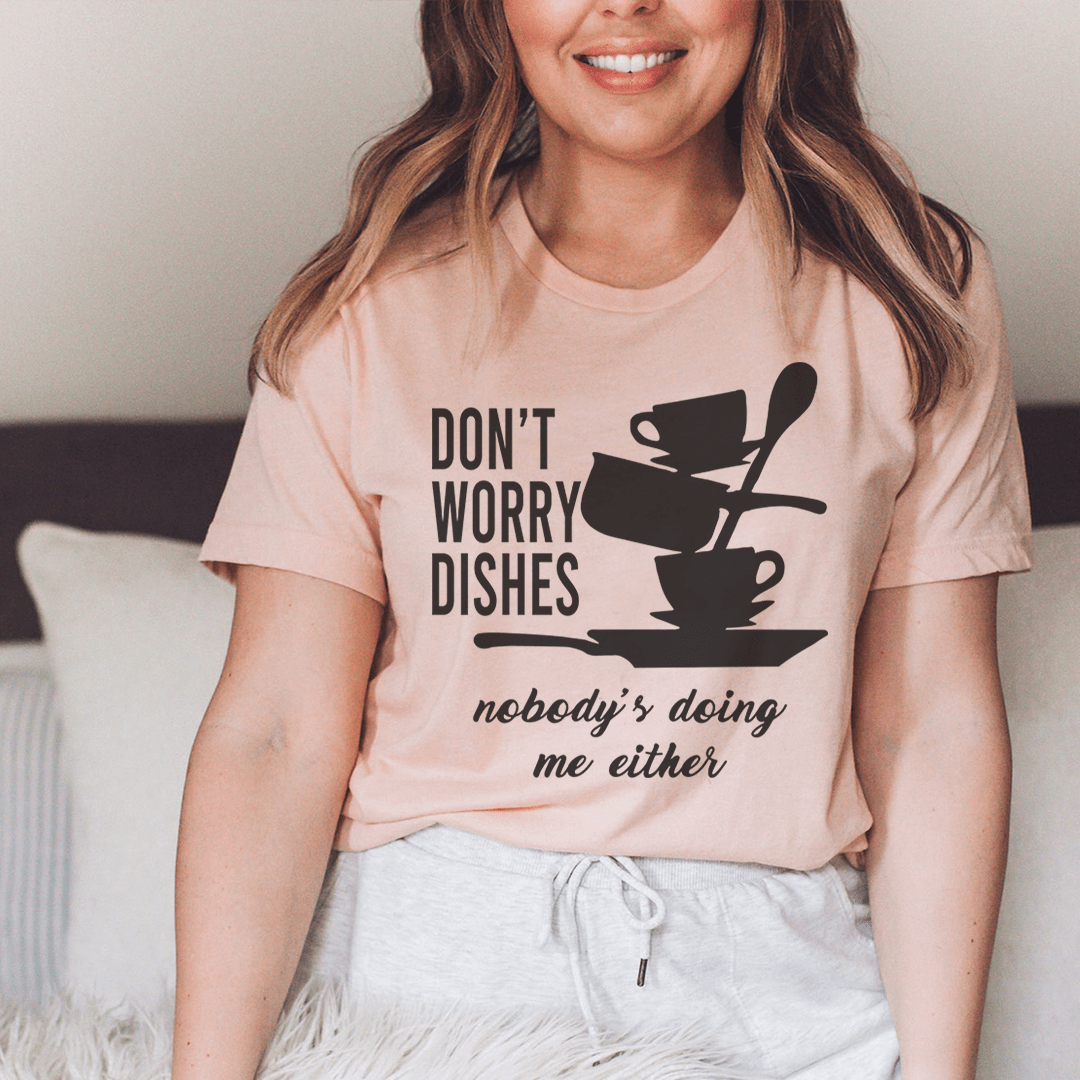 A comfortable Don't Worry Dishes Nobody's Doing Me Either Tee made from soft ring-spun cotton, featuring a playful graphic design.